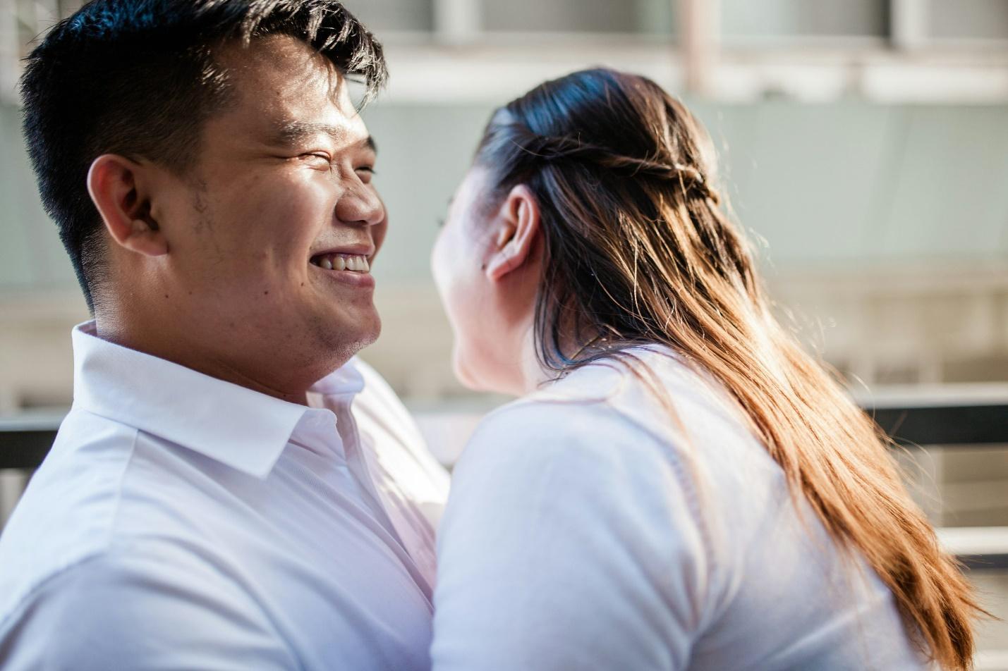 man in white polo shirt kissing woman in white shirt