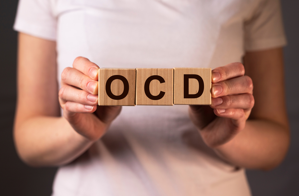 A close-up of wooden blocks arranged to form the word OCD.