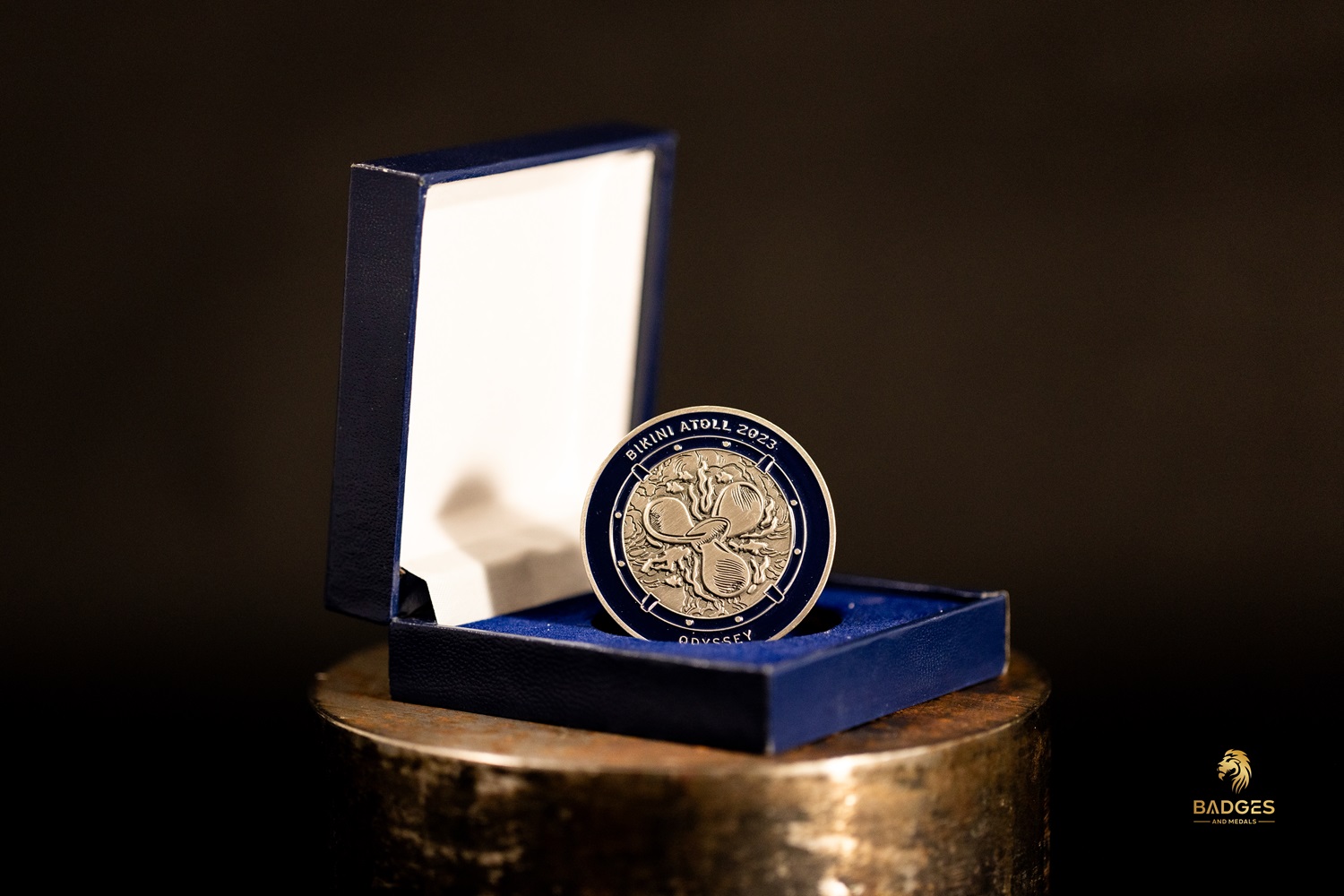 Custom challenge coin in a blue custom challenge coin box.