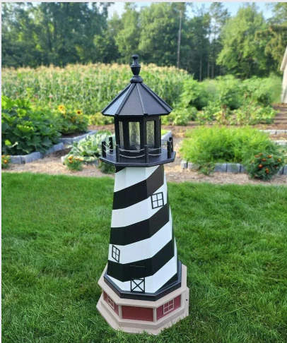 US handmade products: Black and white poly windmill with small black windows displayed in garden setting