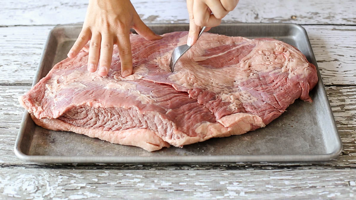 Poke holes using a fork prior to putting marinade on beef brisket