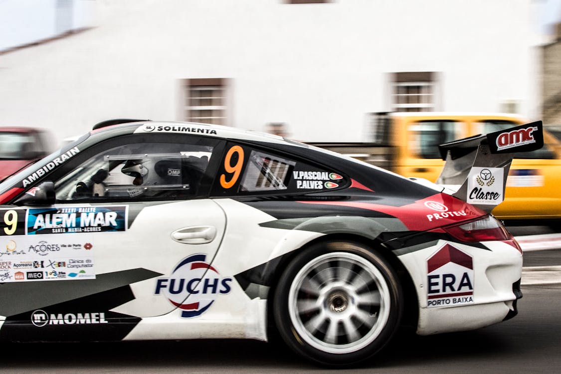 Free Dynamic shot of a sports car speeding by a city street race track. Stock Photo