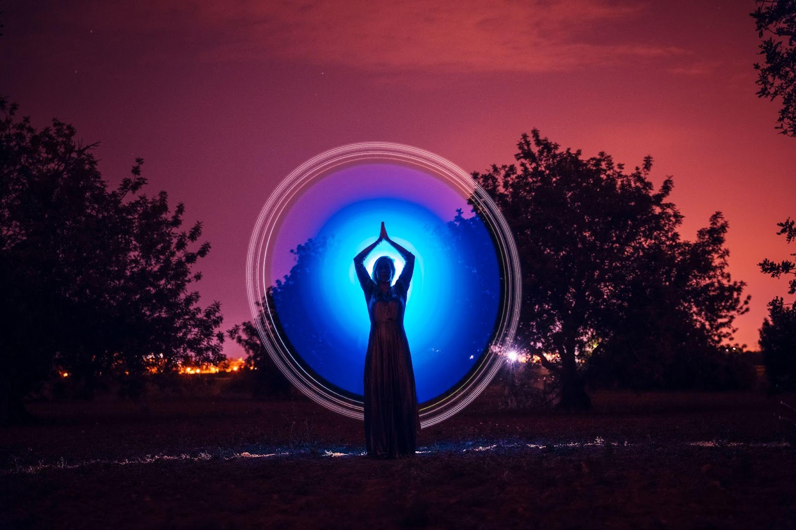 woman in shadow with blue aura behind her