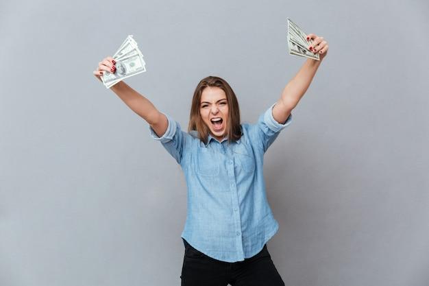 Screaming woman in shirt holding money