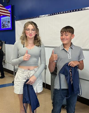 image of two students giving a thumbs up sign