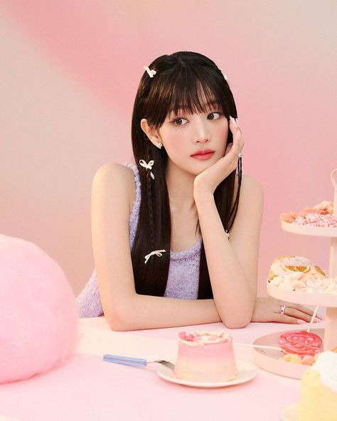 This  contain an image of GIDLE Minnie sitting at a table with some cakes and cupcakes in front of her