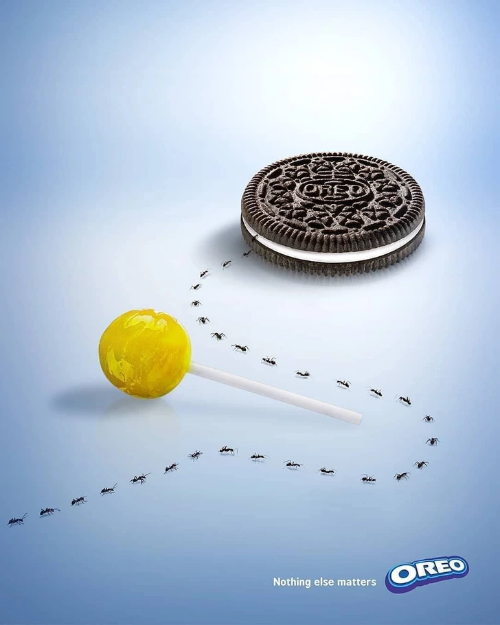 An Oreo add of ants row skipping a lollipop to reach an oreo cookie