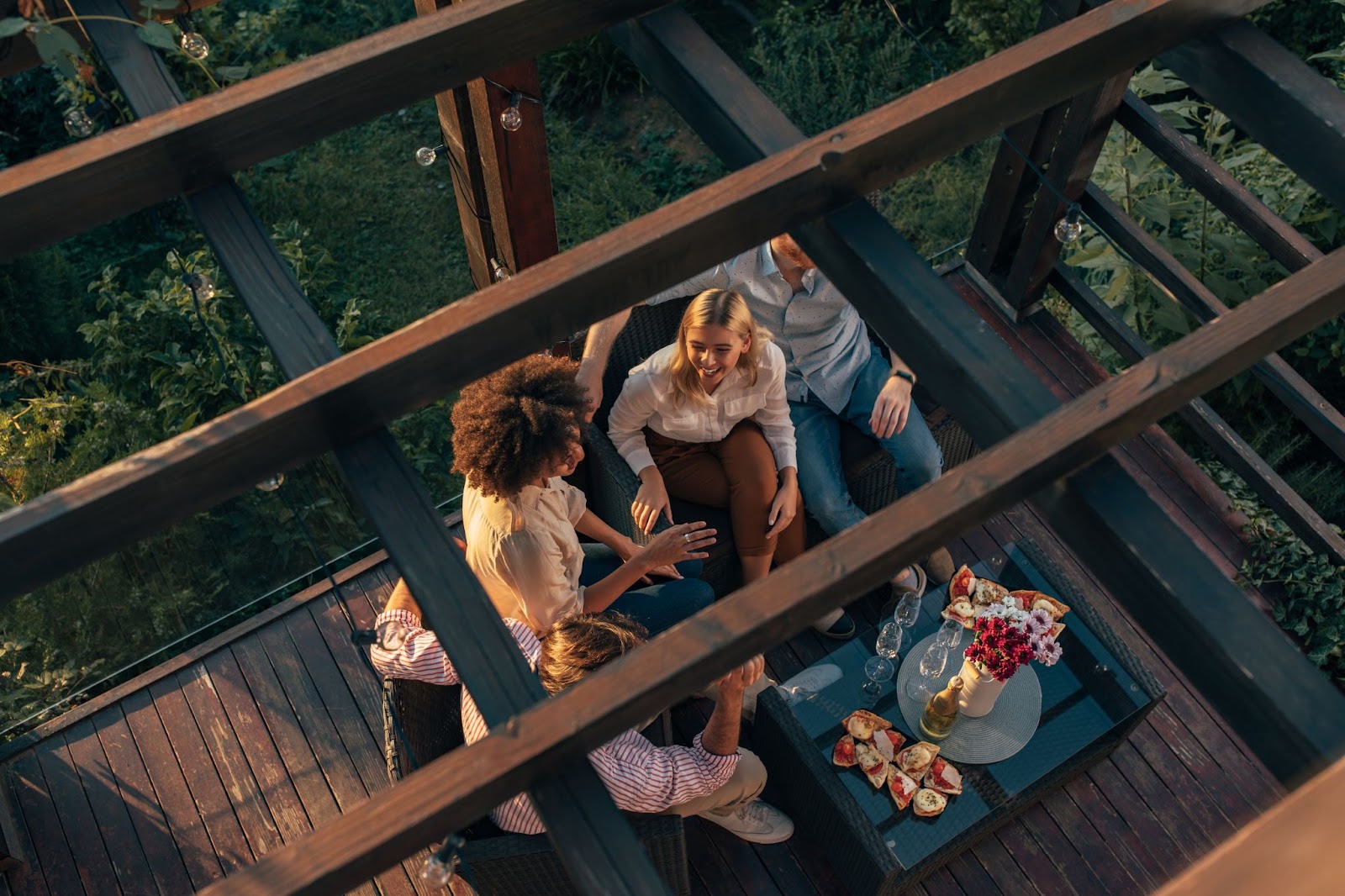 Four friends sharing stories on the patio.