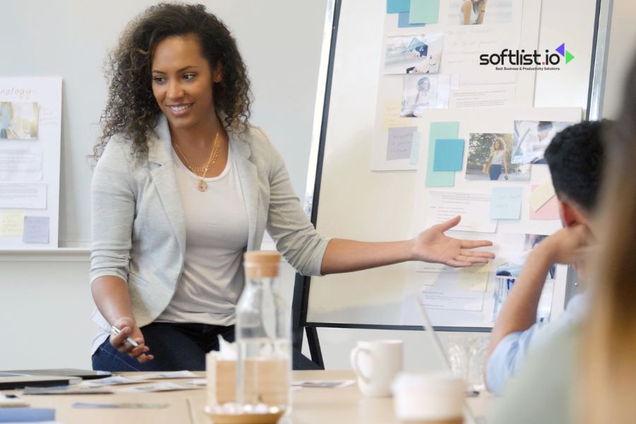 Woman presenting at a meeting with a whiteboard.