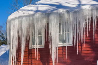 essential winterizing tips for your michigan home ice dam hanging off roof in winter custom built okemos