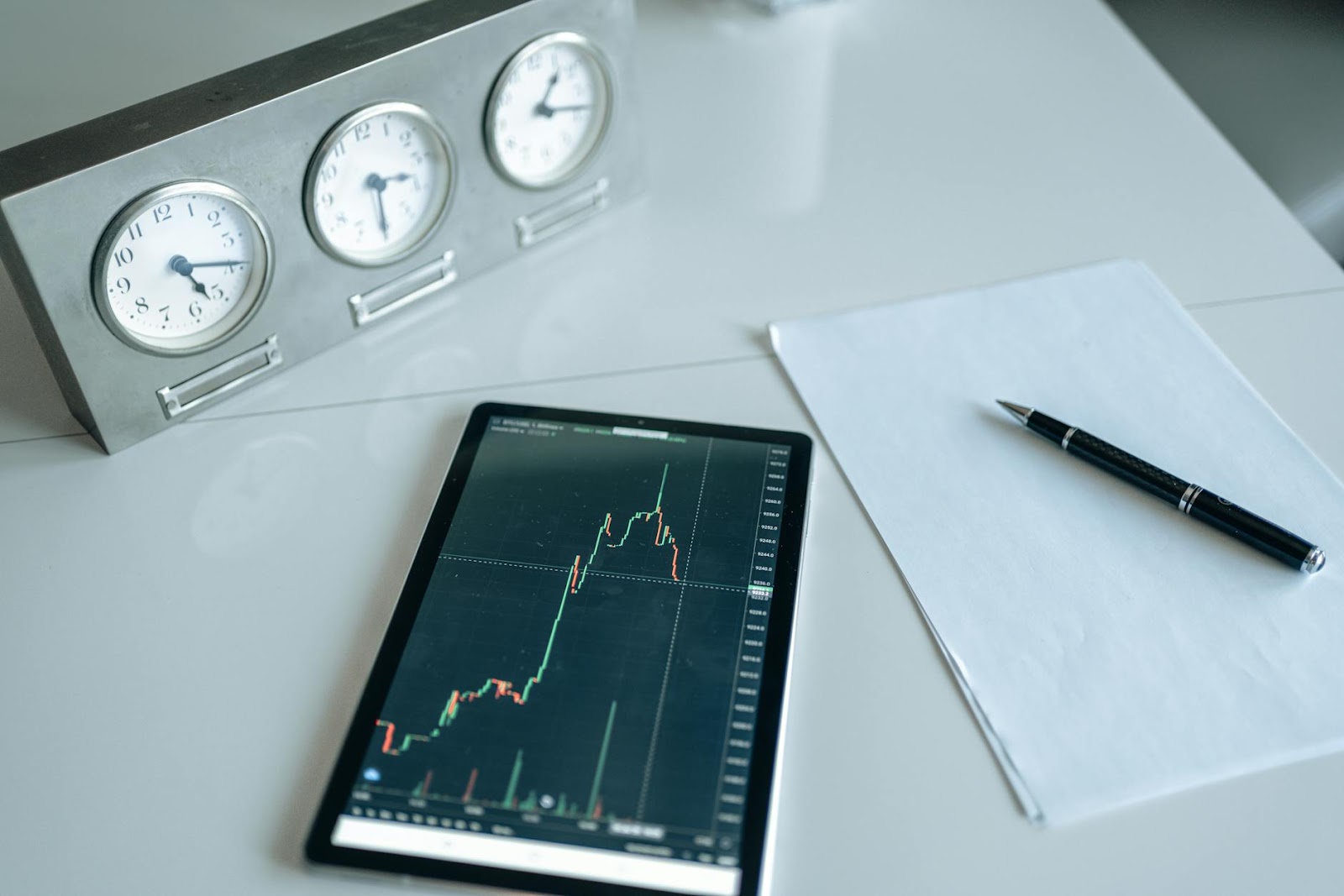https://www.pexels.com/photo/a-tablet-device-between-analog-clock-and-blank-white-paper-on-a-white-surface-5833794/