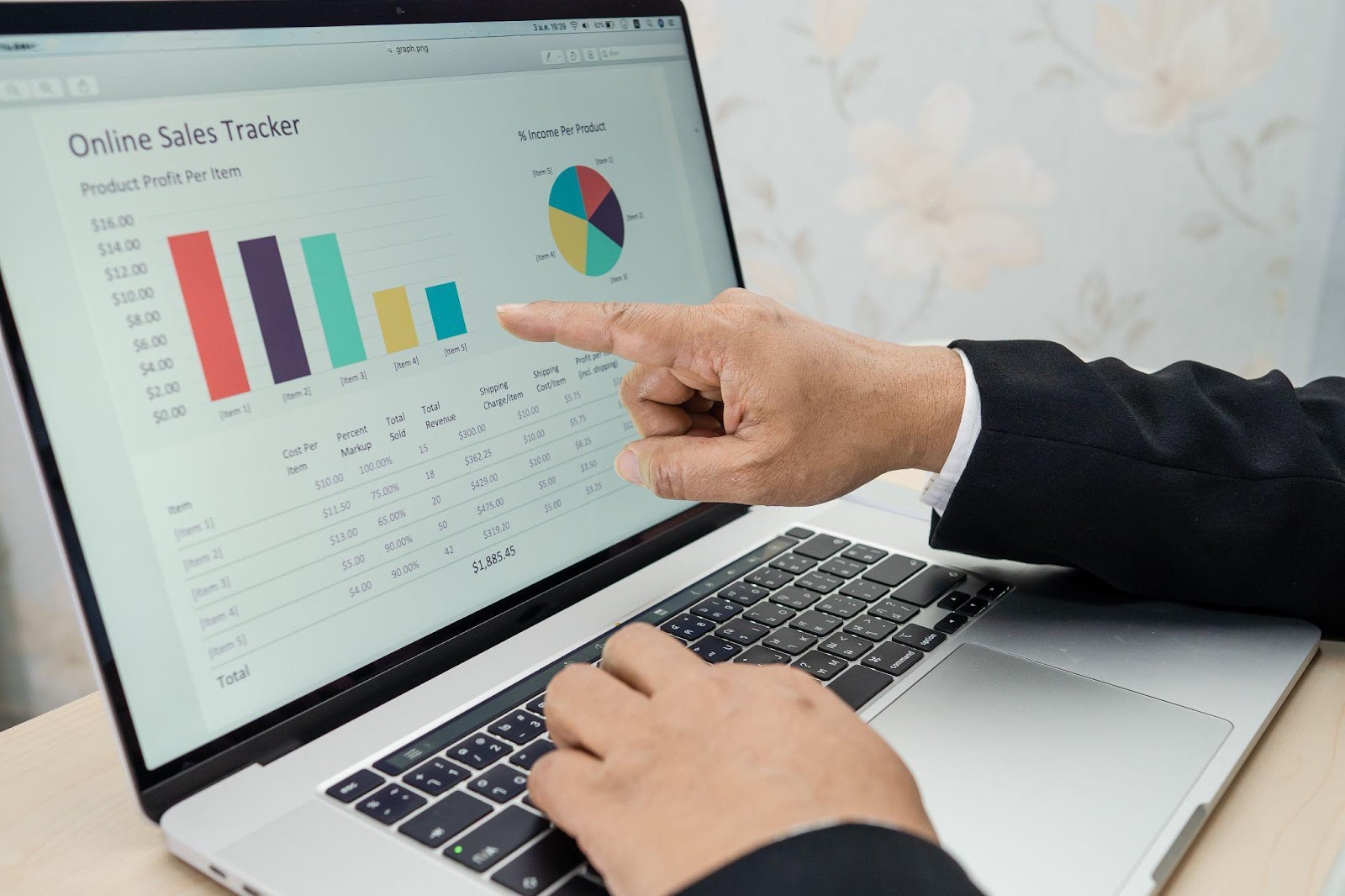 man pointing out at ecommerce data on his laptop screen