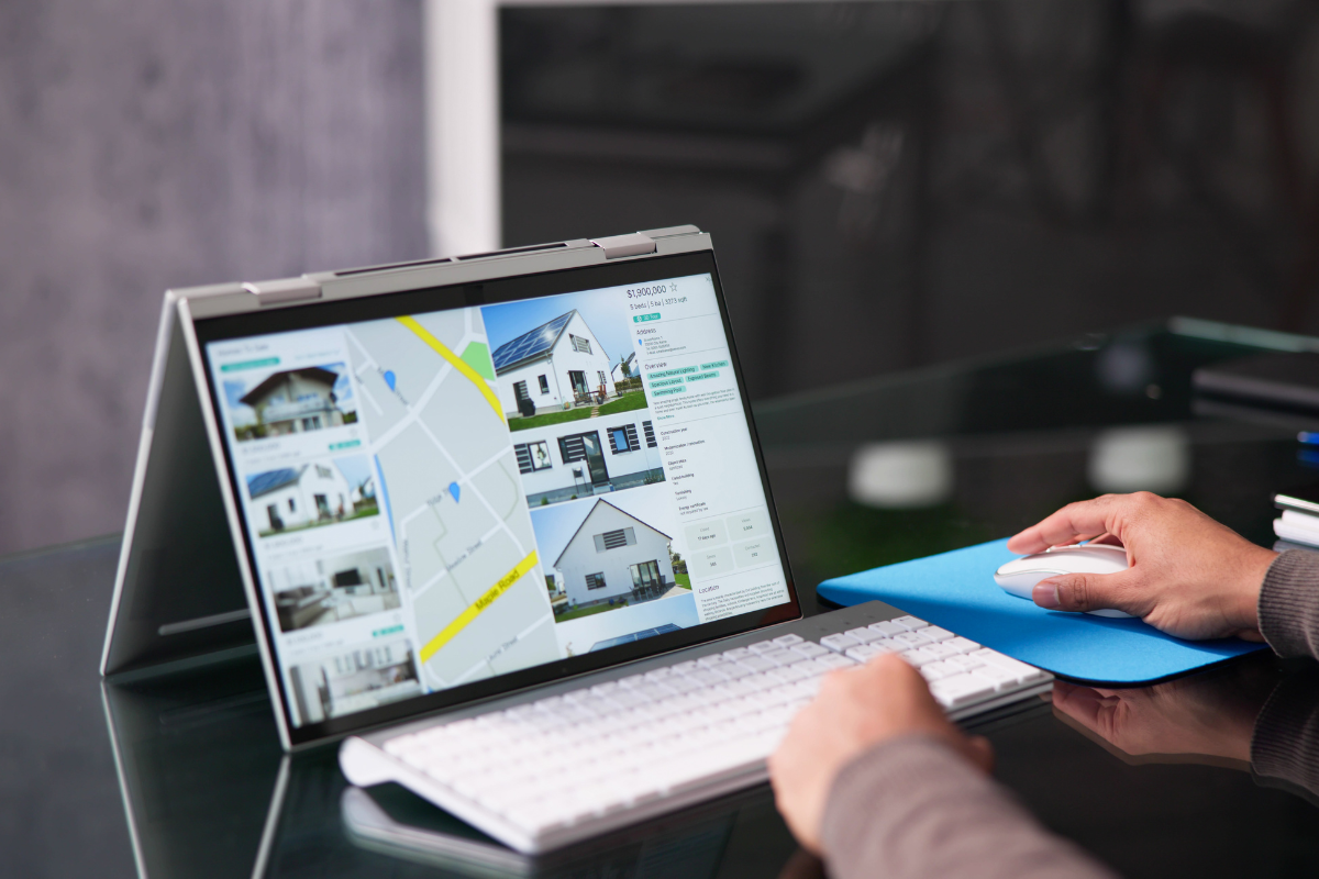 using a laptop to look at a real estate website