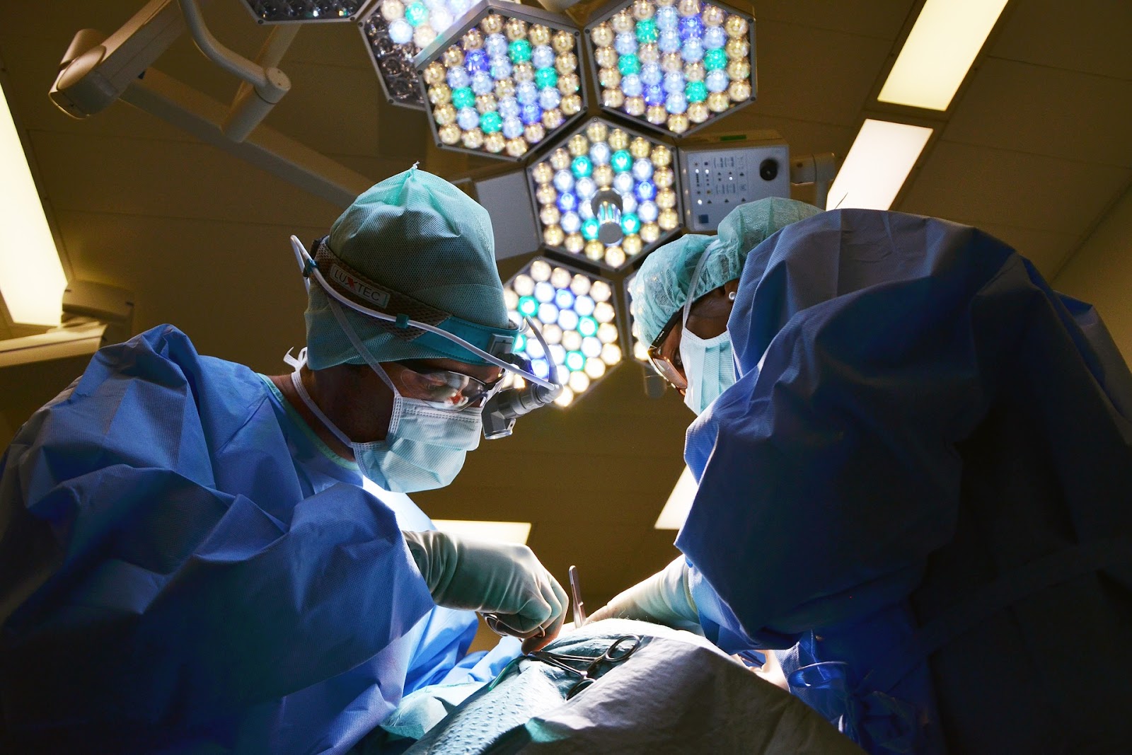 Two dentists work together on a patient, performing a dental procedure with precision and care for optimal results.