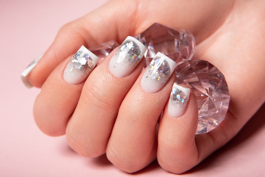 Crystal-encrusted tips add a luxe touch to classic French nail tip design.