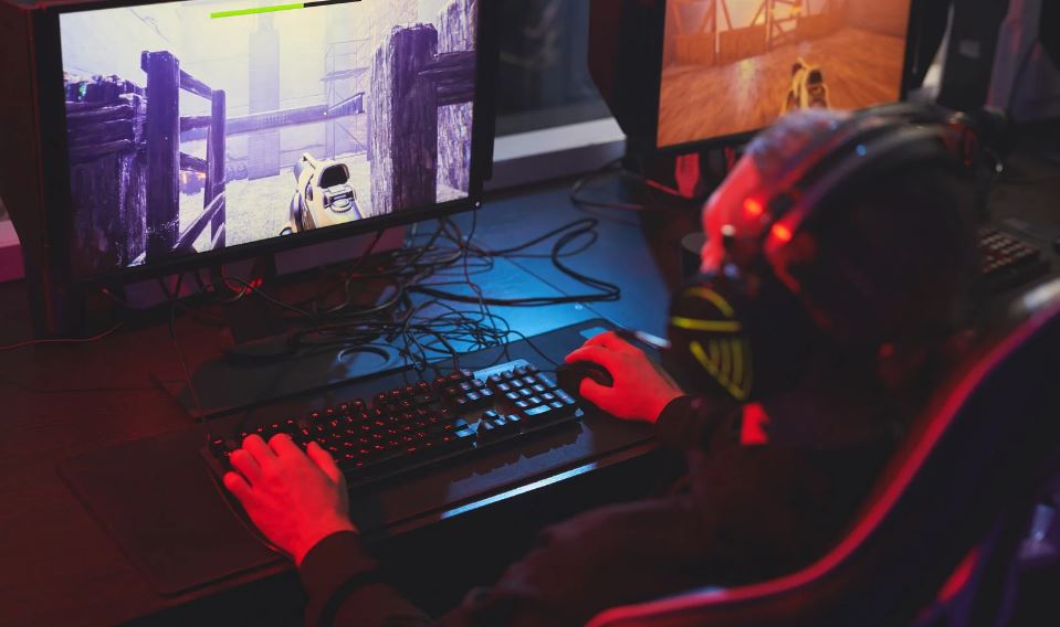 a man playing PC game in a gaming chair