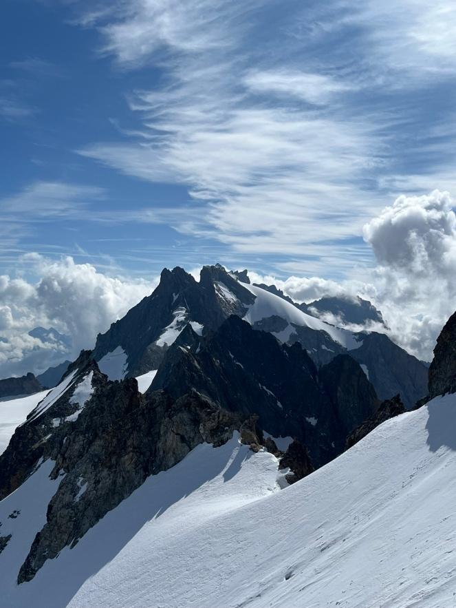 A mountain range with snowAI-generated content may be incorrect.