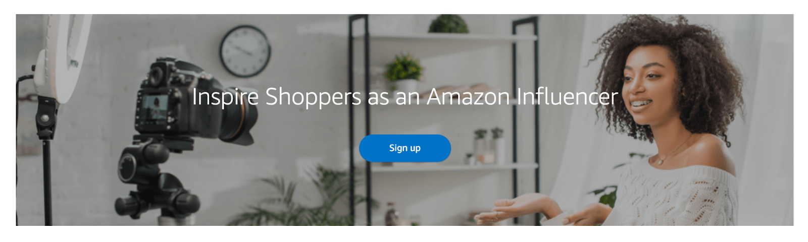 A banner showing a woman recording a video and prompting users to sign-up with the message "Inspire Shoppers as an Amazon Influencer"