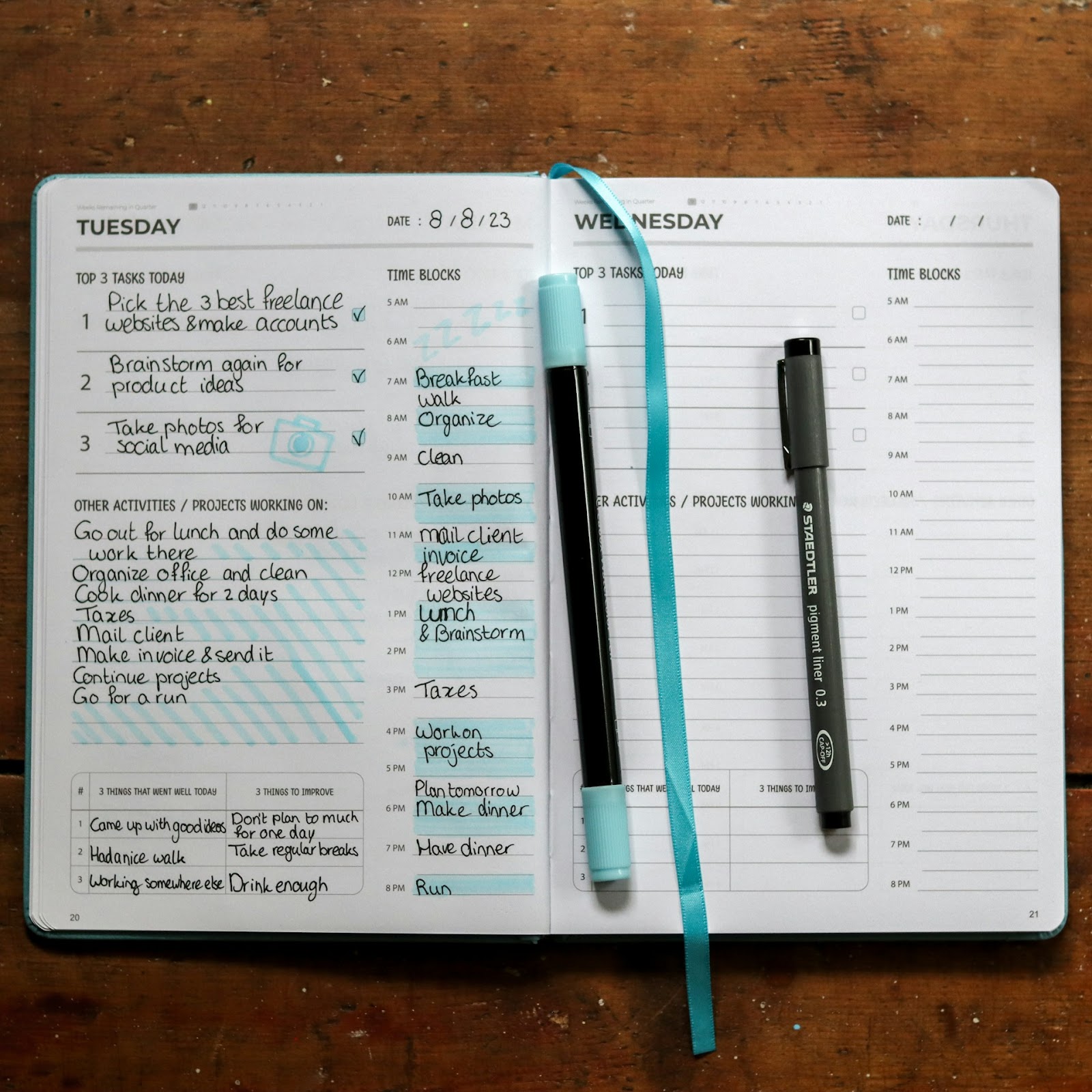 A daily planner, pen, and notebook ready for organizing tasks and jotting down notes.