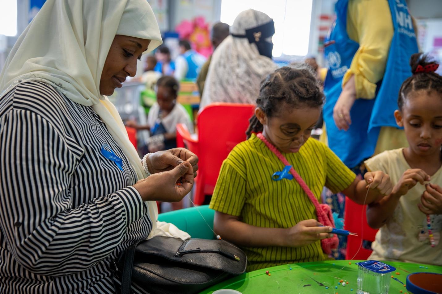 A person and child sitting at a table</p>
<p>AI-generated content may be incorrect.
