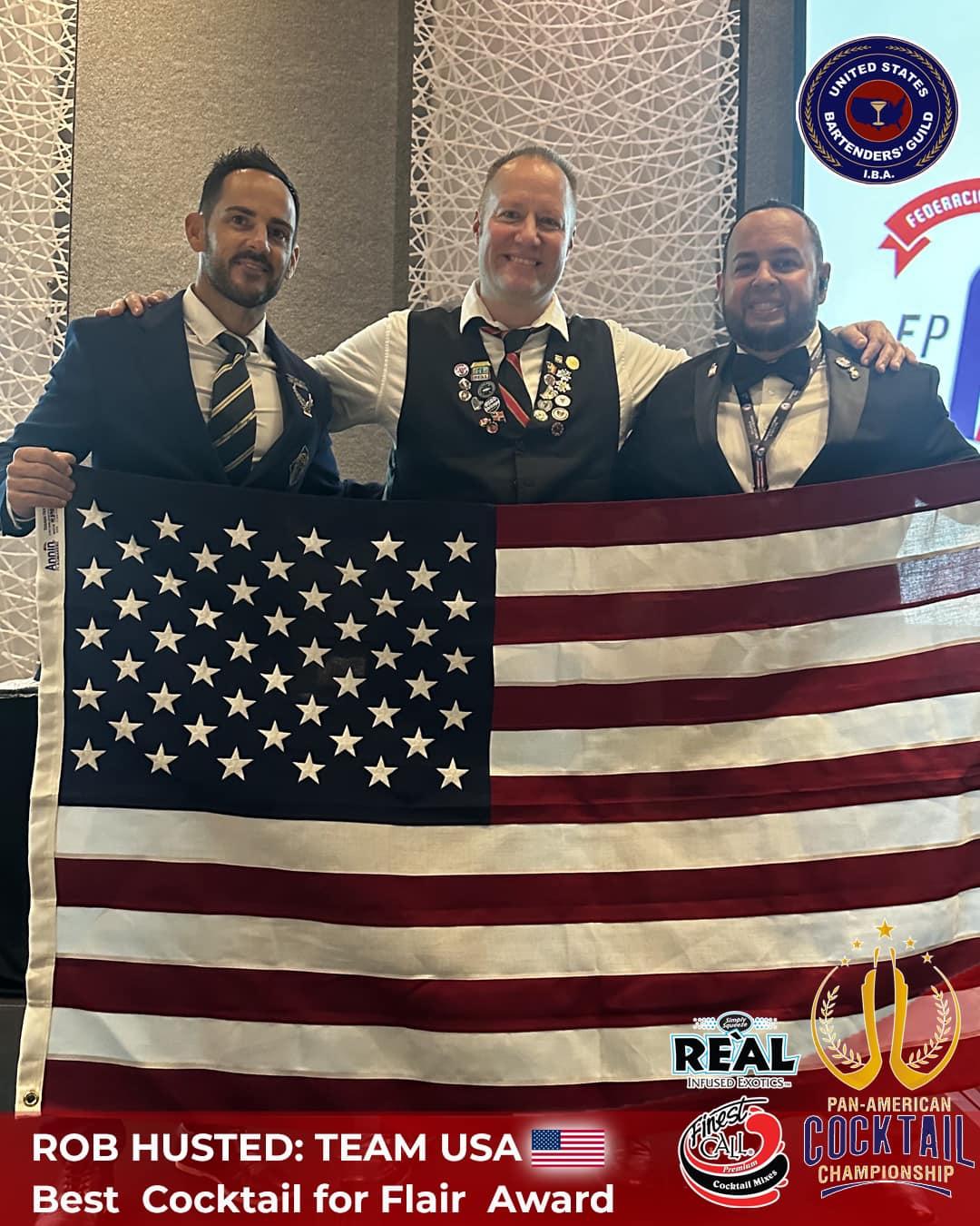 A group of men holding a flag

Description automatically generated