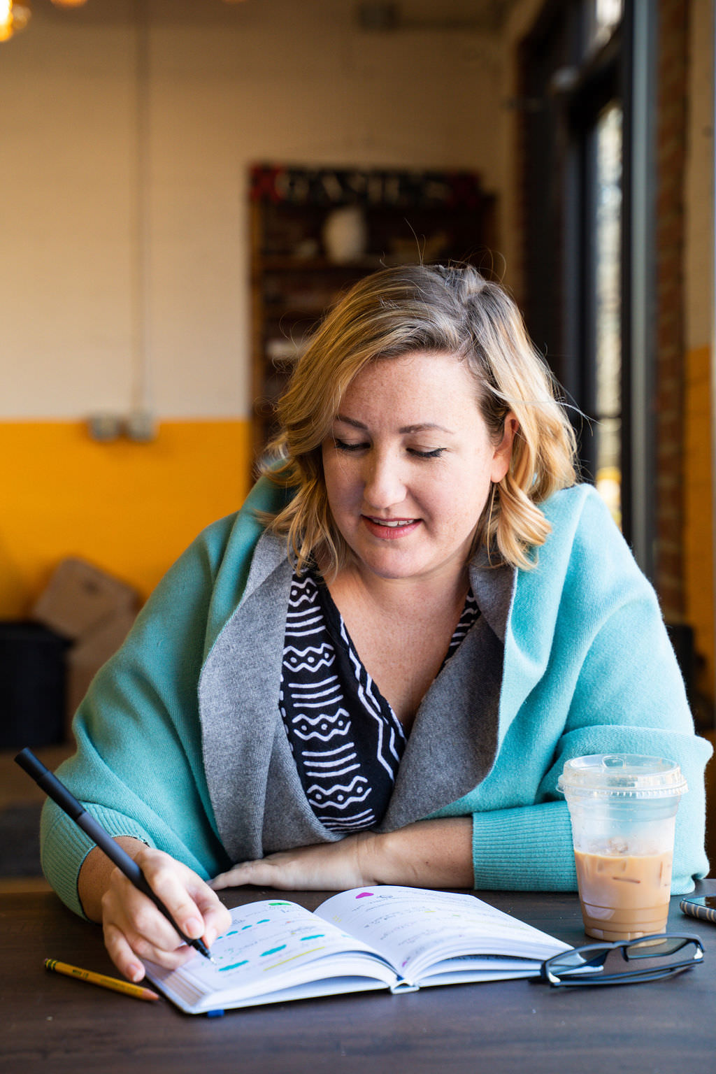 woman writing on core values journal