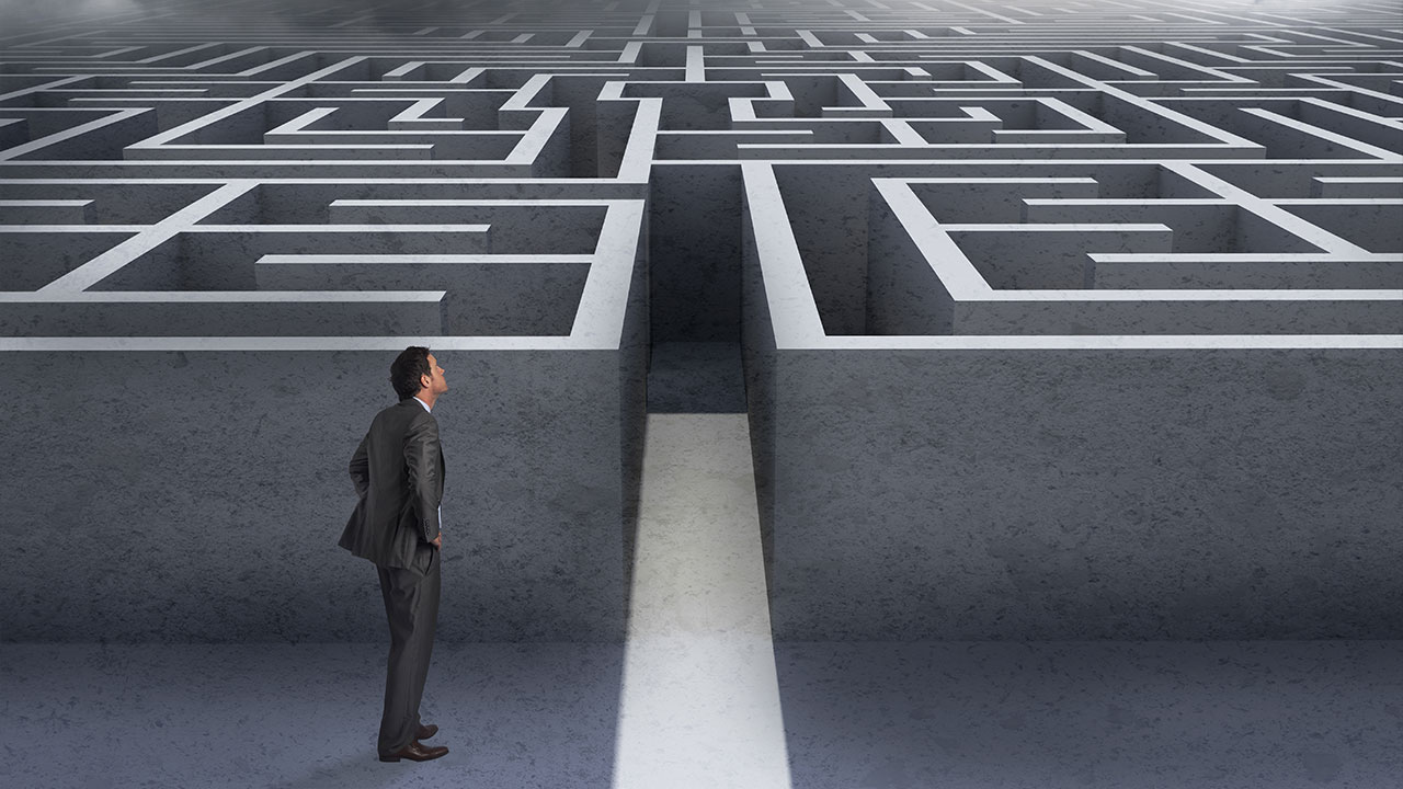 Confused person standing in front of a maze, symbolizing the complexity of deciding between building or buying software features.

