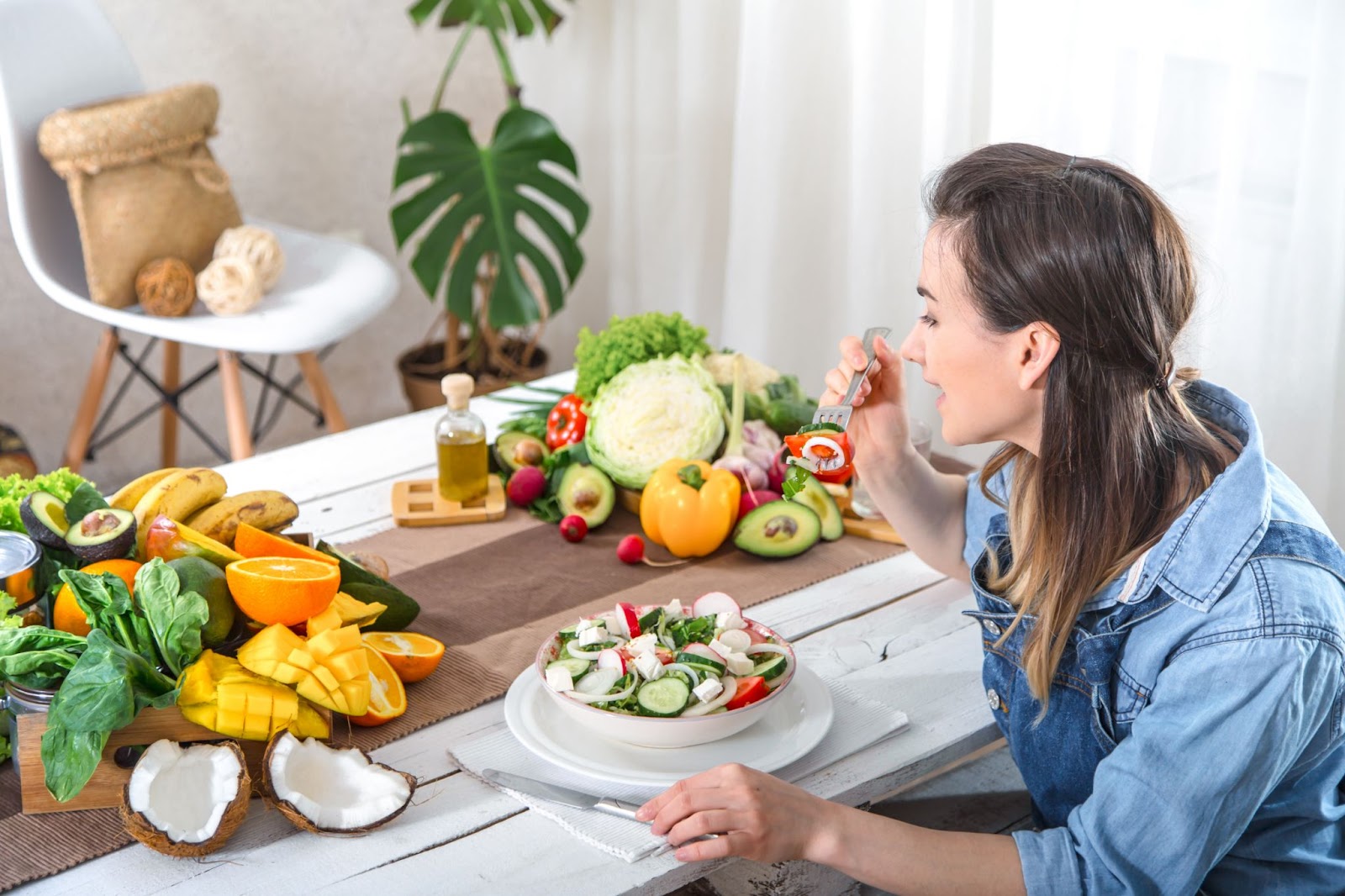 A woman is seen eating veg salad  that is best for vegan food for beginners.