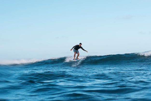 Sporty man surfing in hawaii