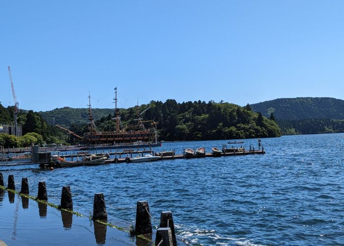 The Lake Ashi cruise ship that looks like a pirate ship, pulling back in to pick up new passengers.