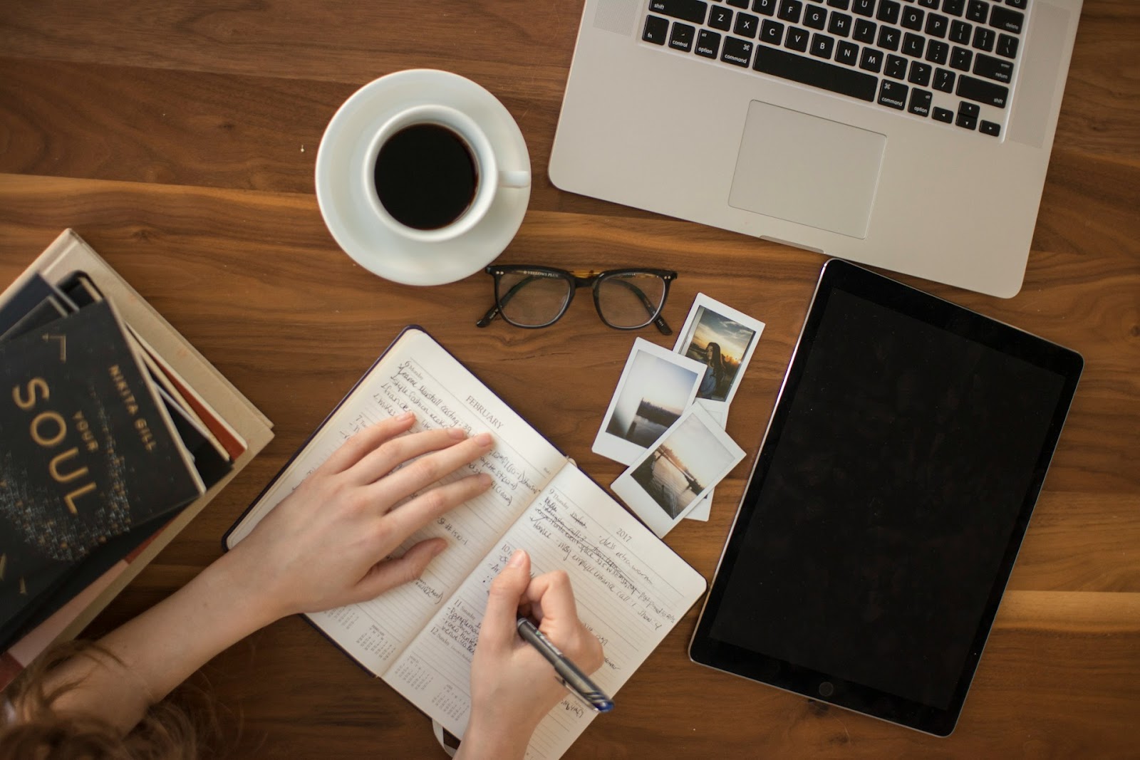 A woman writing activities on her journal for weekly review