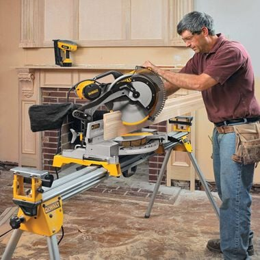 This image depicts a miter saw resting on a piece of wood for a home improvement project.