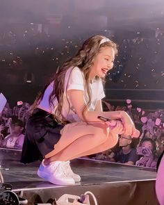 This contains an image of  BLACKPINK Jennie on stage with fans cheering her