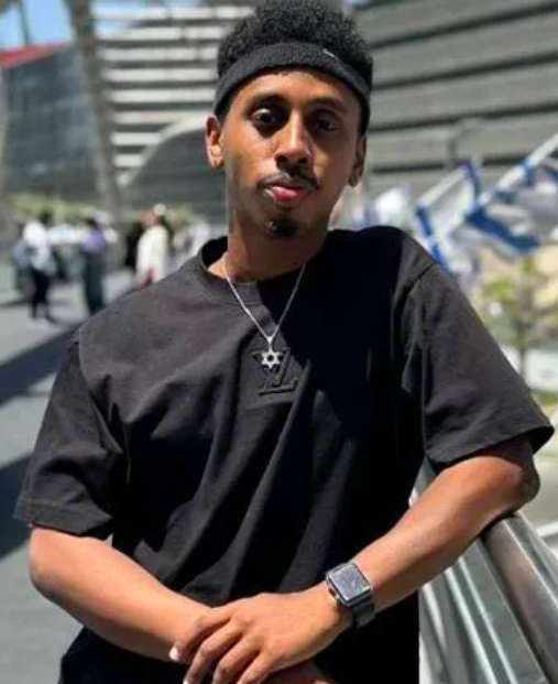 This is a picture of Johnny Somali wearing a black t-shirt