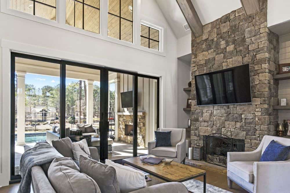 Lodge room with a stone fireplace, vaulted ceiling, and clerestory windows.