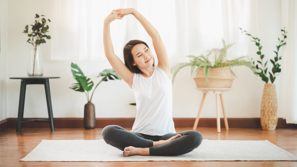 Woman stretching on a mat.