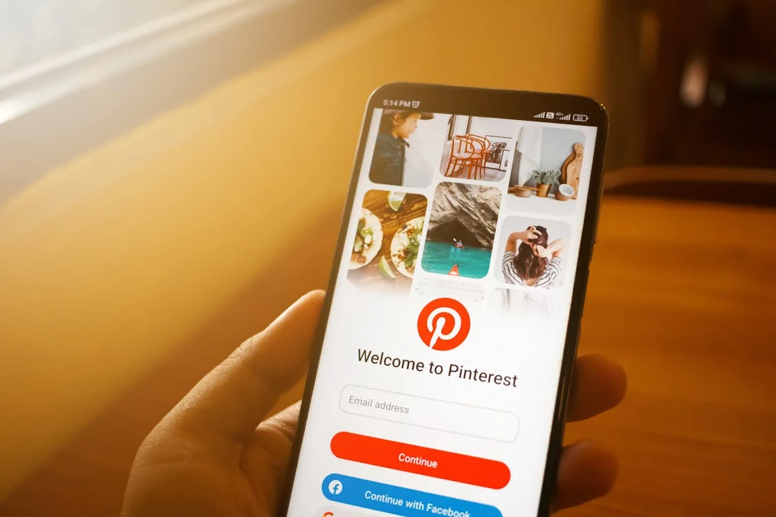Pinterest website displayed on a smartphone held by a user, highlighting mobile engagement with visual content