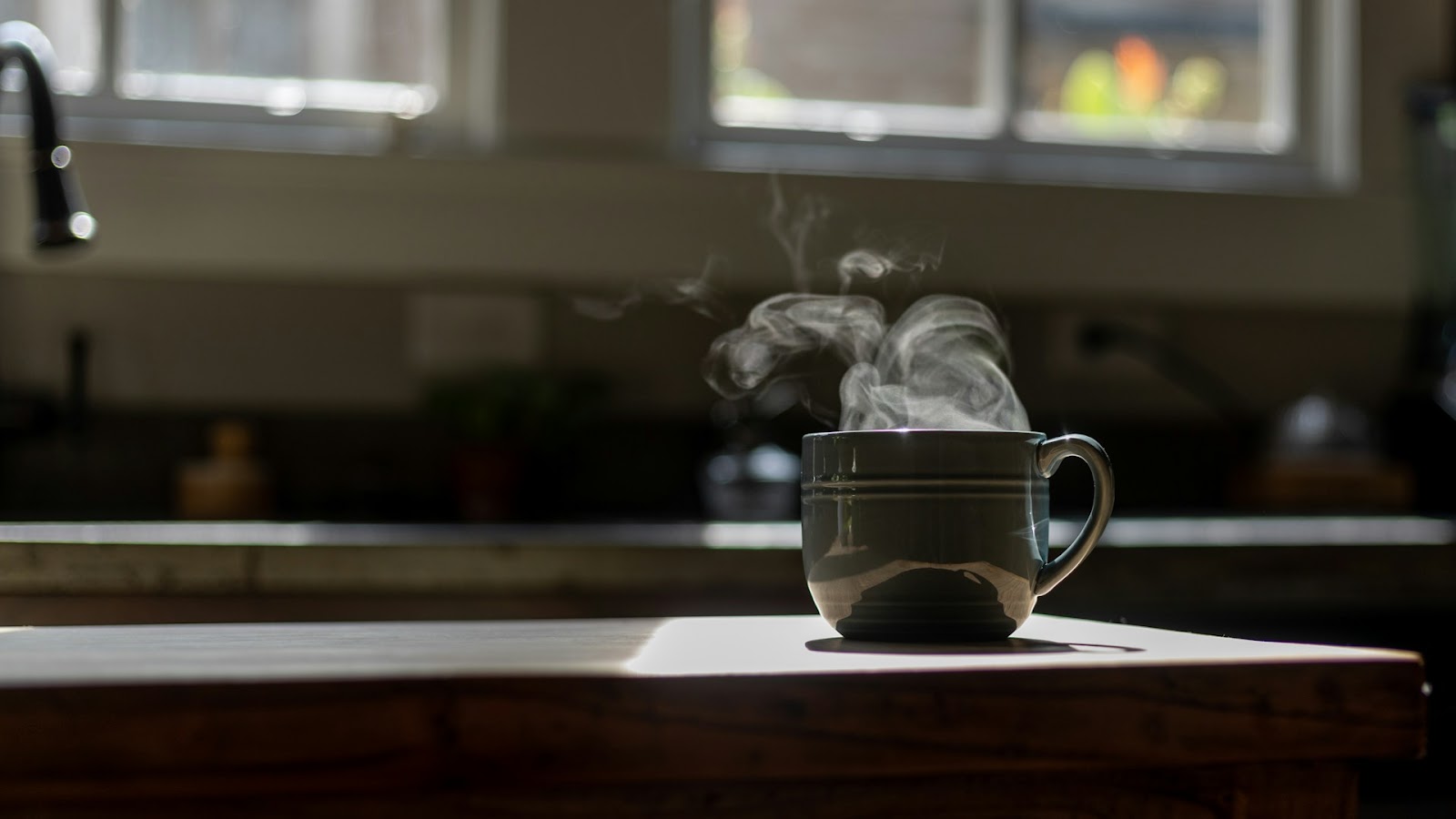 A steaming cup of tea on a kitchen work counter