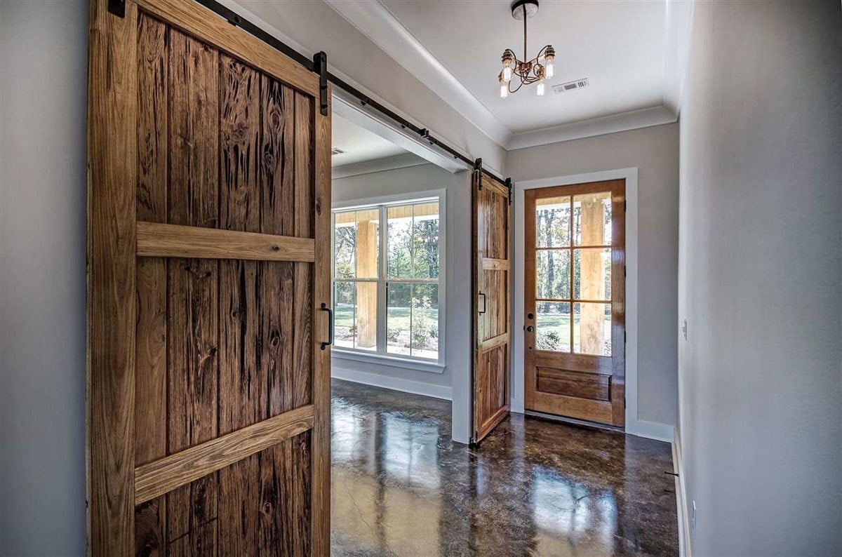 The foyer has a glass chandelier and barn sliding doors to its left leads to the formal dining room.The foyer has a glass chandelier and barn sliding doors to its left leads to the formal dining room.