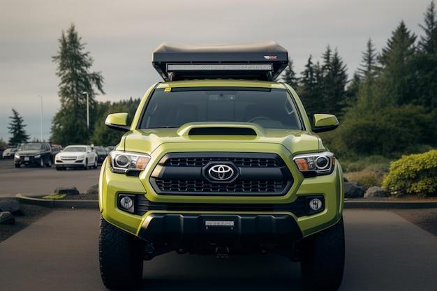 A green toyota tacoma with a roof rack on the roof.