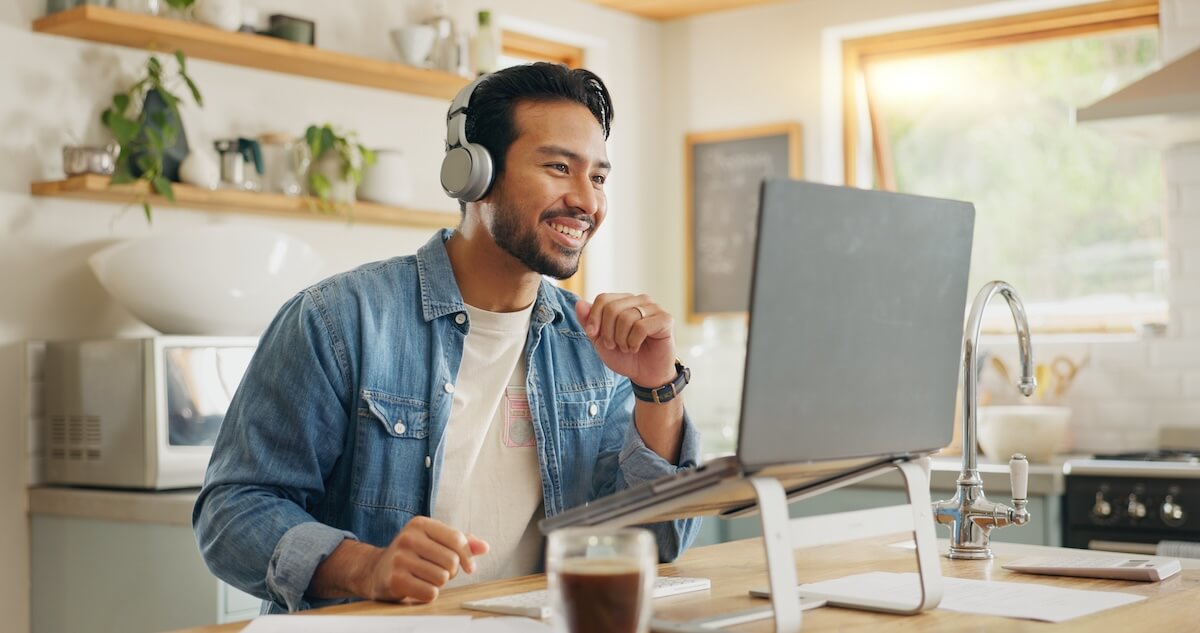 Remote work policy: employee wearing headphones while looking at his laptop