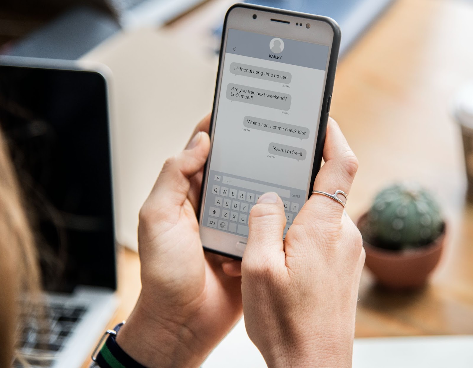 Woman chatting with a friend on her smartphone using Google Chat