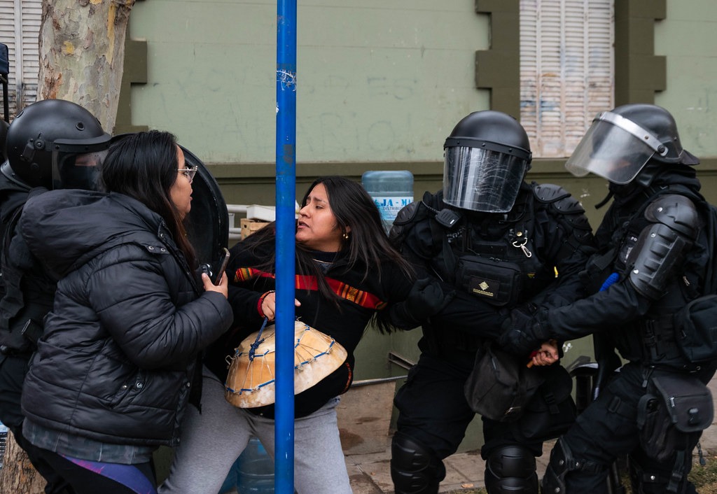 Una mujer intenta liberarse de la polícía en la represión del 20 de julio.