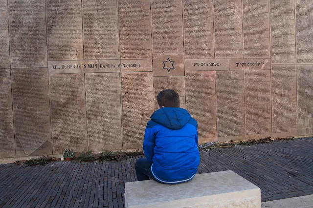 man sat at jewish memorial