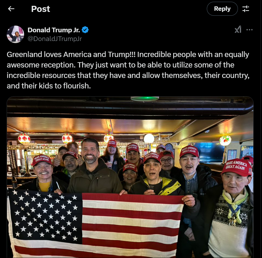 A group of people holding a flagDescription automatically generated