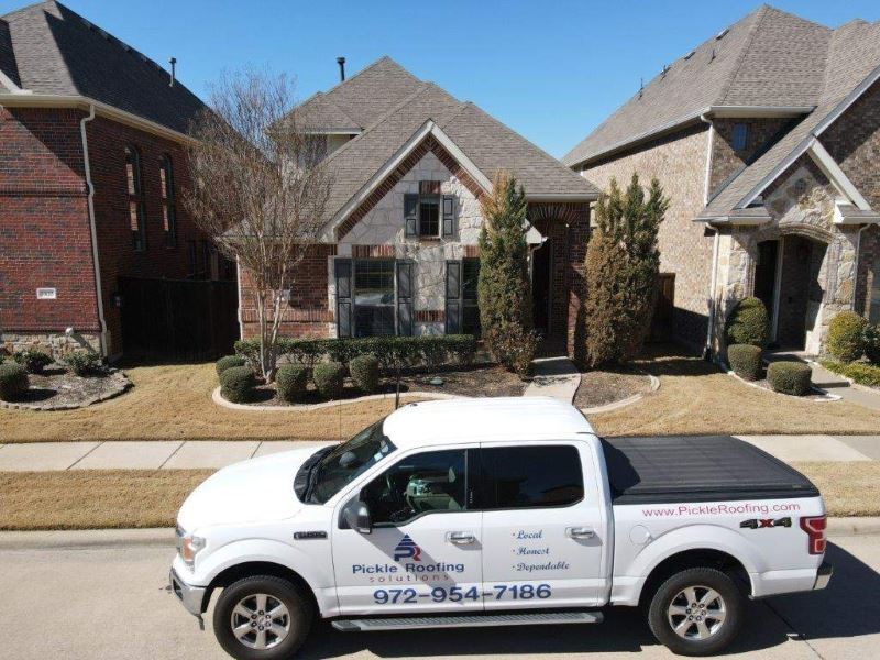 Pickle Roofing car outside a client's home