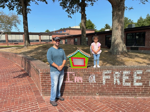 image of Mr. Ventura and a FES student posing with the outdoor free library