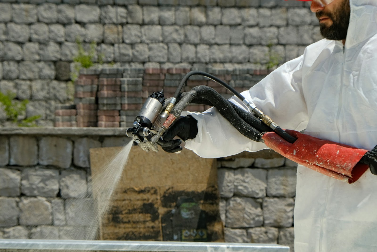 Man using pressure washing method. 