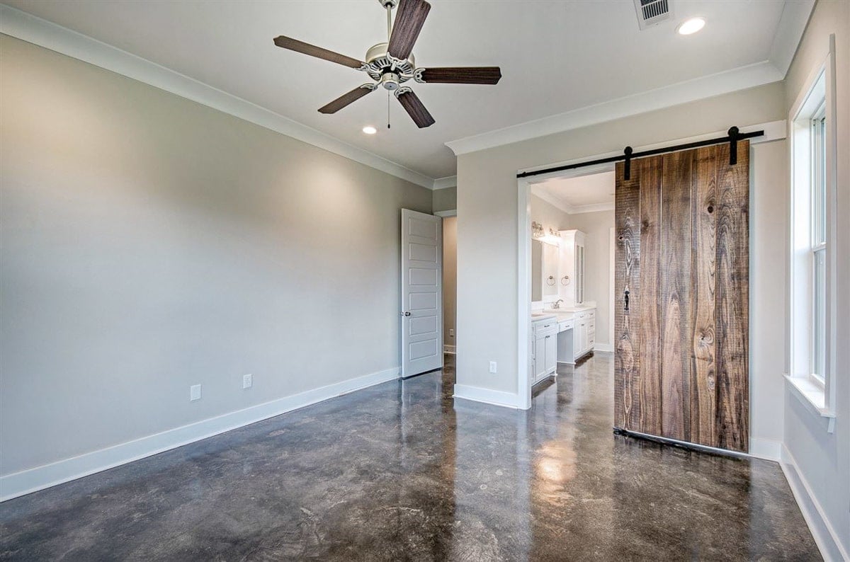 The primary bedroom includes a private bath enclosed in a sliding barn door.
