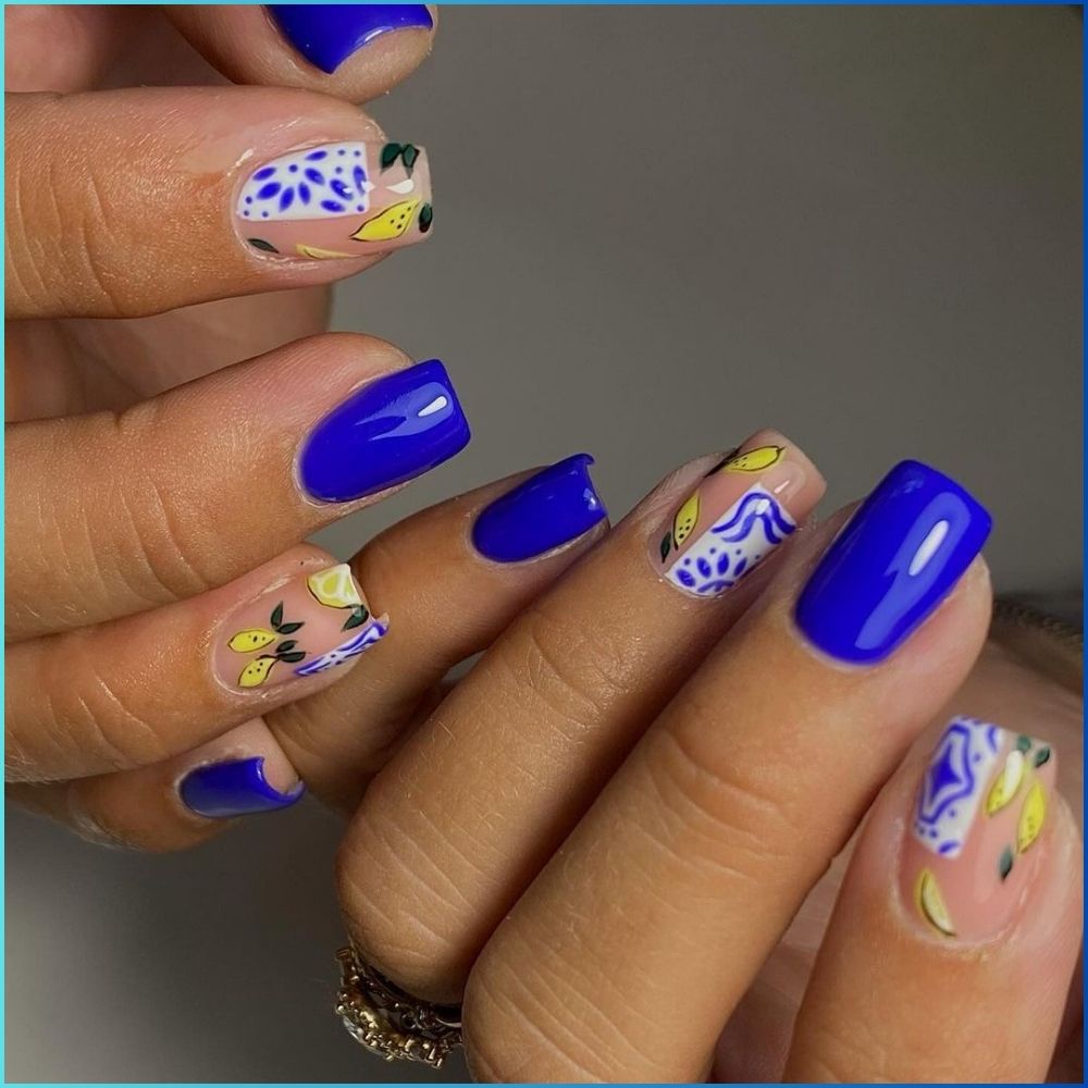 Close up of hands with flowered designed blue nails having Mediterranean Cruise and a mix of darkish blue color